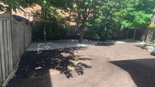 2021-Low-maintenance-riverstone-under-shade-trees-in-backyard-plus-soil-grading-and-addition-prior-to-sod-installation