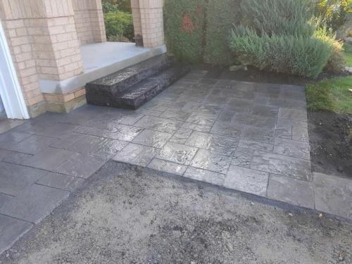 2021-Stacked-stone-steps-and-large-interlock-tile-patio-at-front-of-home-in-Whitby-Unilock-Windermere-Granite-Blend-Flagstone
