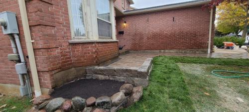 2021-l1-Natural-stone-wall-border-and-new-garden-bed-created-at-end-of-interlock-walkway-in-Whitby-Unilock-Brussels-with-retaining-wall