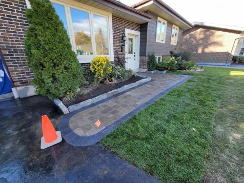 2021-n4-Replacement-interlock-path-with-curved-border-and-natural-stone-garden-wall-in-Whitby-Unilock-Brussels-Sierra-with-Midnight-Charcoal-border
