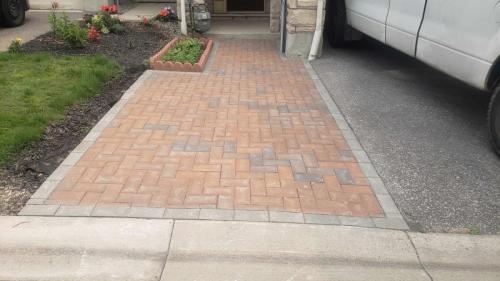2021-t2-Finished-interlock-path-adjacent-to-driveway-incorporated-small-garden-and-red-colour-to-match-Unilock-Holland-Stone
