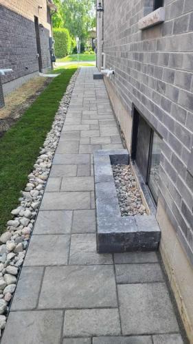 2024-Whitby-Landscaping-Landscaping-18-Sidewalk-Way-Window-Well